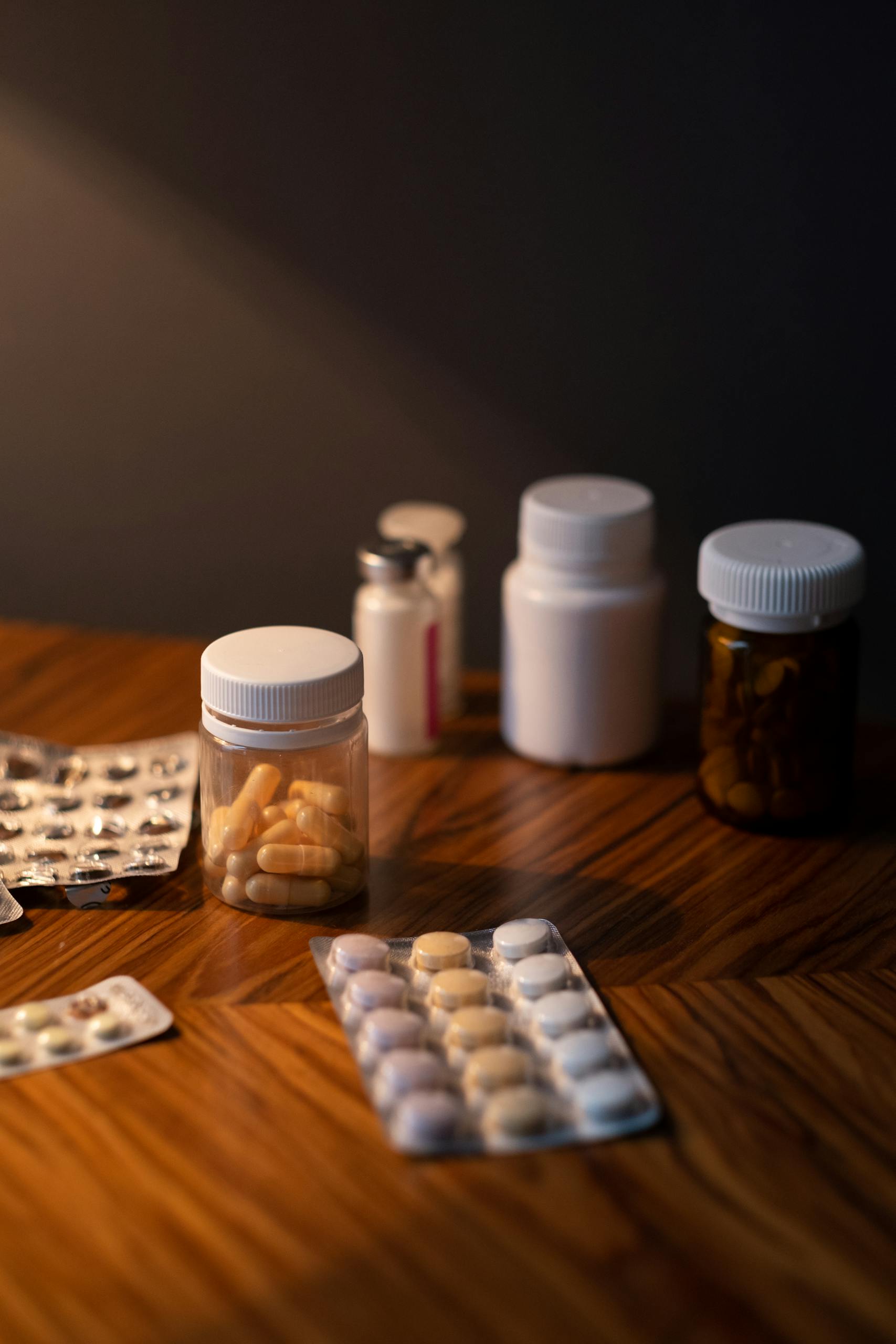 Various pills and medicine bottles on a table as a part of medication management for seniors.